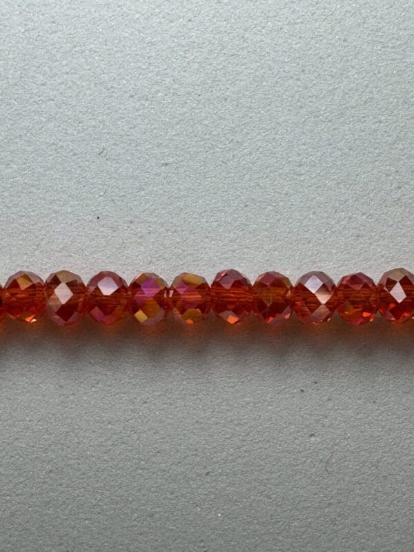 Row of red faceted glass beads.