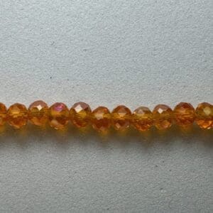 Row of iridescent amber glass beads.