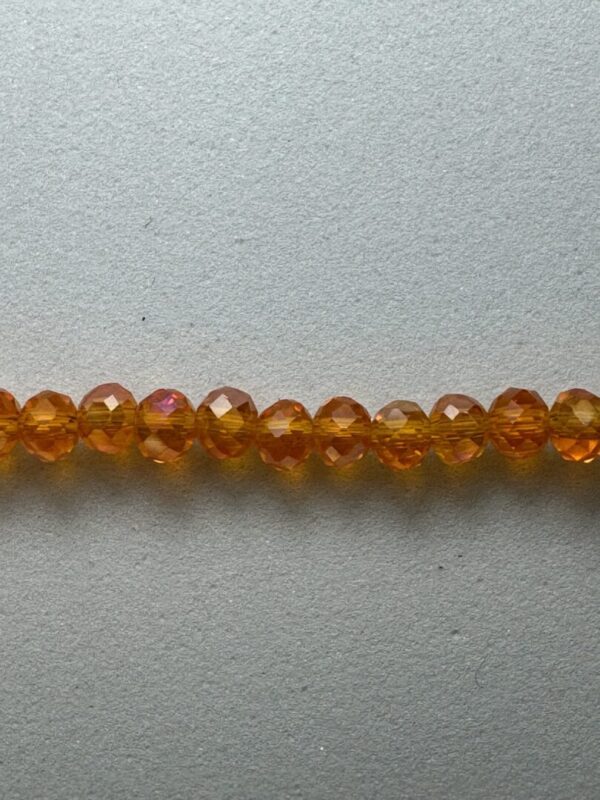 Row of iridescent amber glass beads.