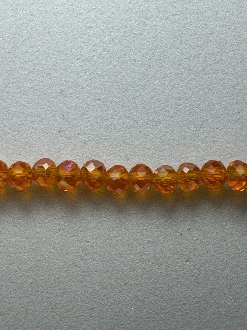 Row of iridescent amber glass beads.