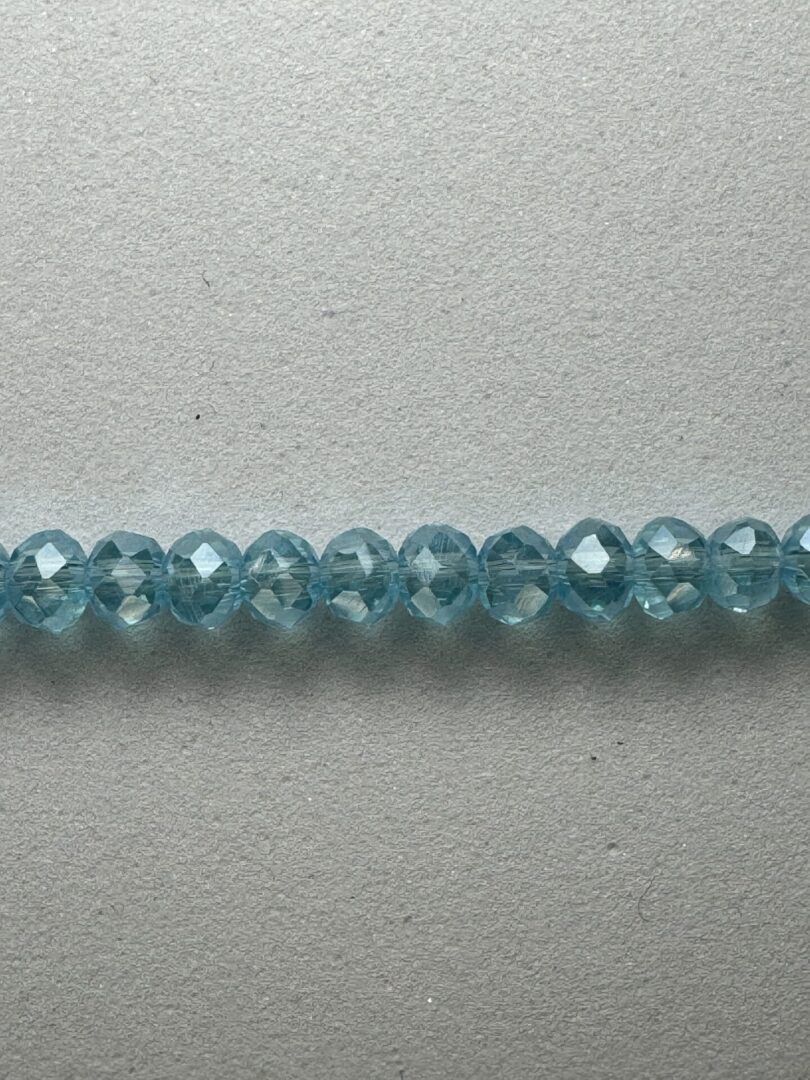 Row of light blue faceted beads.