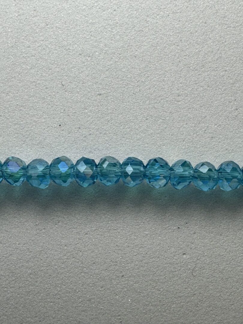 Row of light blue faceted beads.