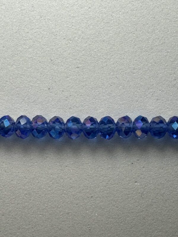 Row of blue faceted glass beads.