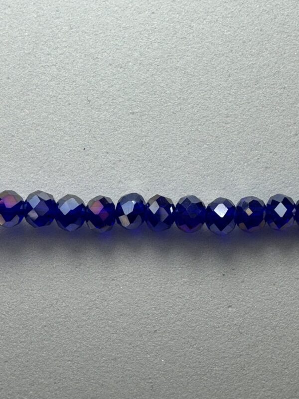 Row of blue iridescent glass beads.