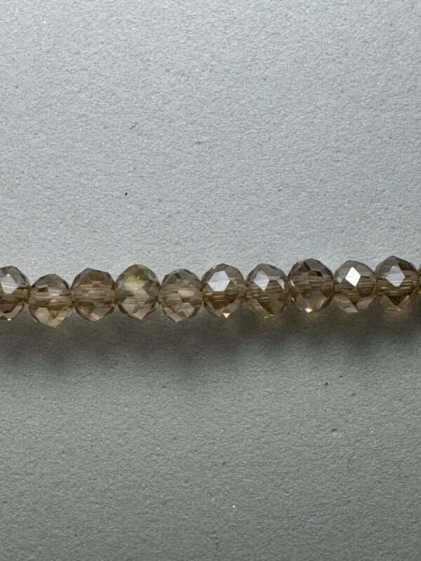 Row of brown faceted glass beads.