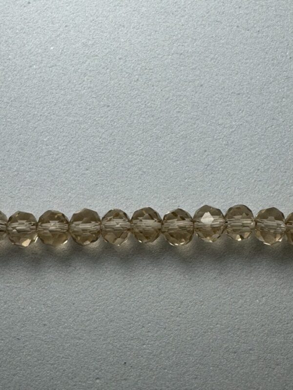 Row of brown faceted glass beads.