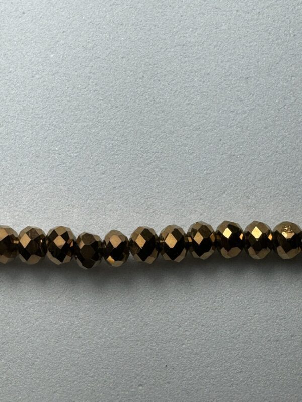 Row of bronze faceted beads.