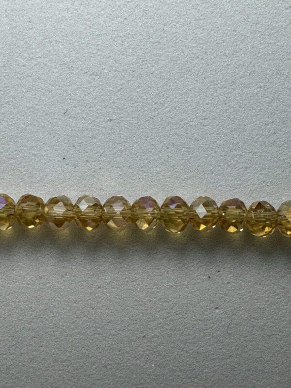 Row of iridescent yellow glass beads.