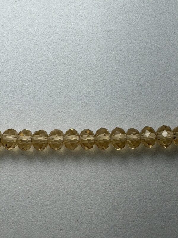 A row of golden faceted glass beads.