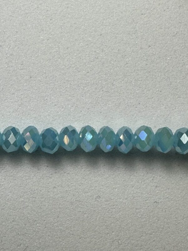 Row of iridescent blue glass beads.