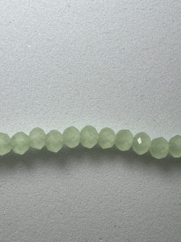 Row of light green faceted beads.