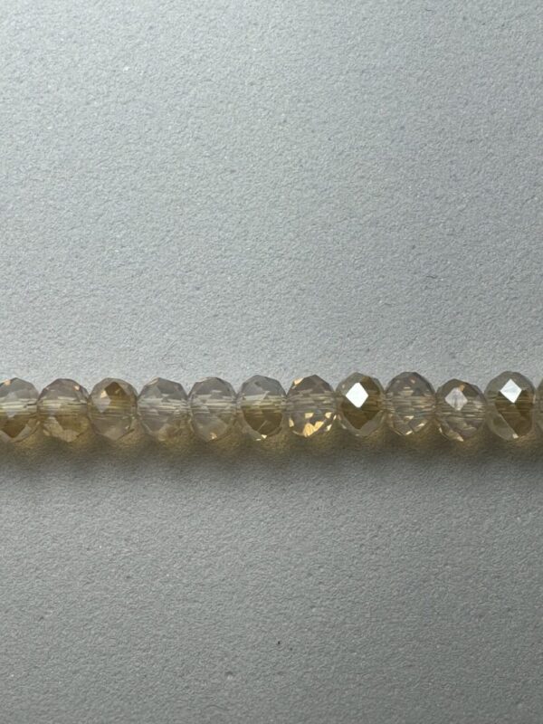 Row of light brown faceted beads.