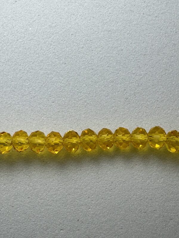 A row of yellow faceted beads.