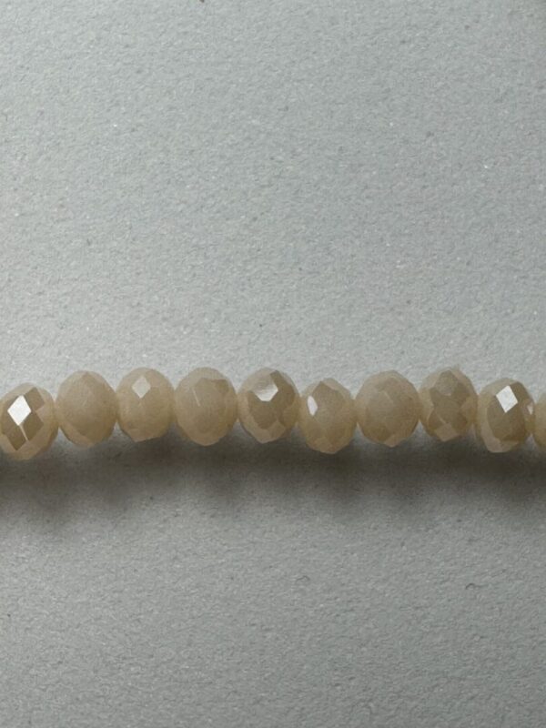 Row of light brown faceted beads.