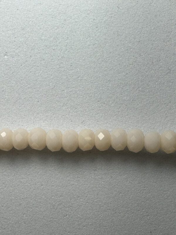 Row of white faceted beads.