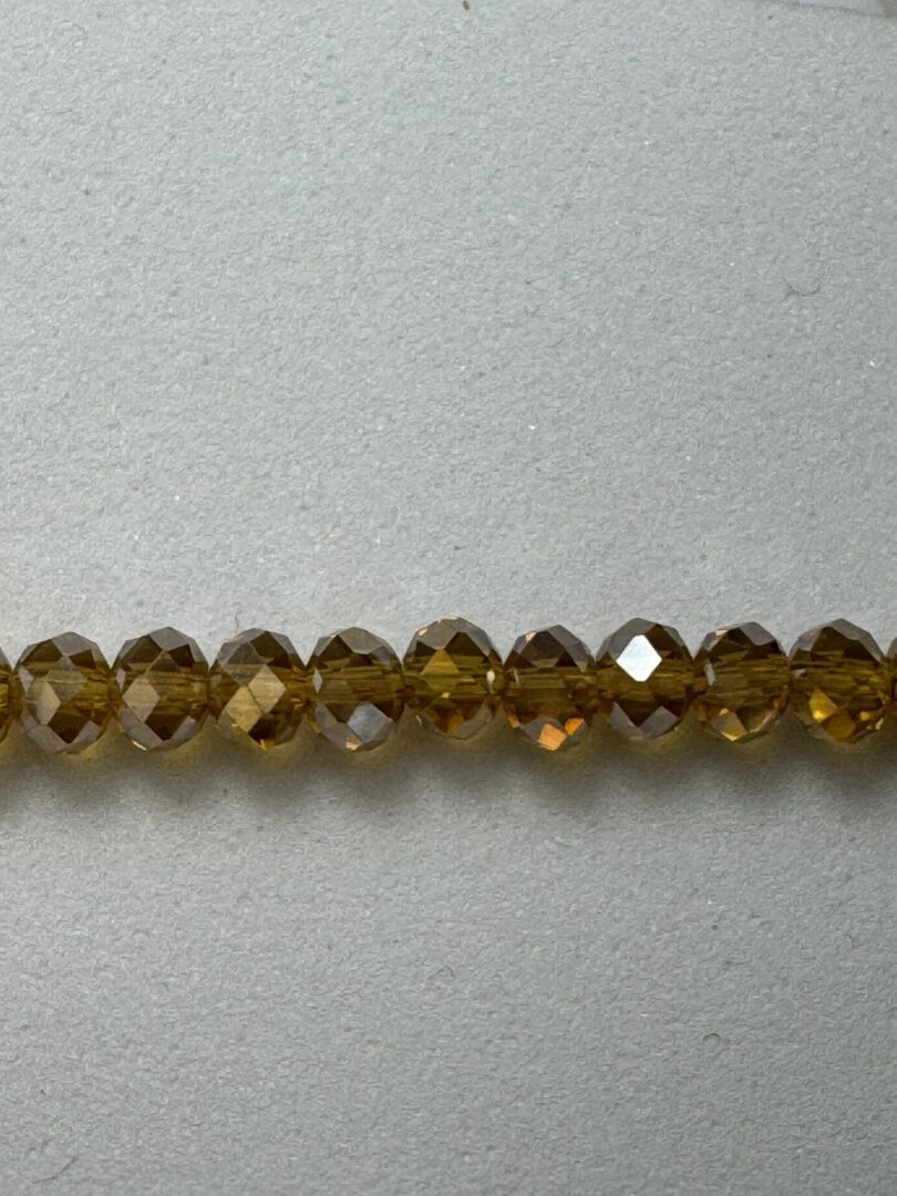 Row of brown faceted glass beads.