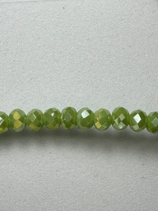 Row of green faceted glass beads.