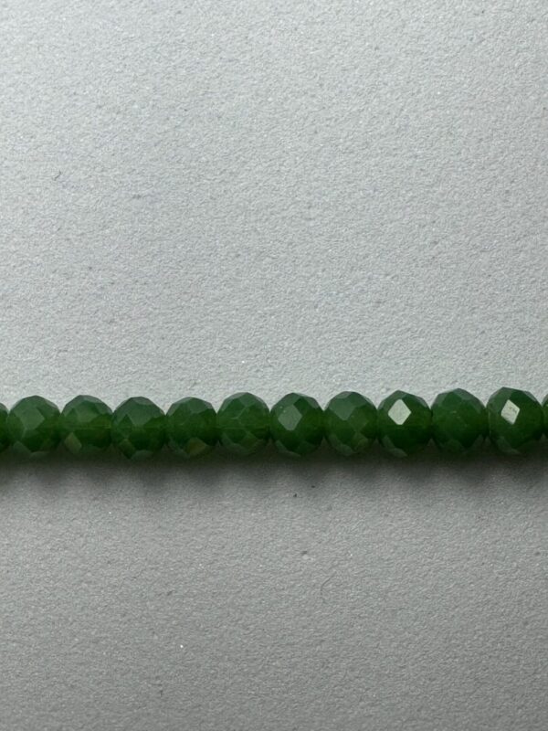 Row of green faceted glass beads.