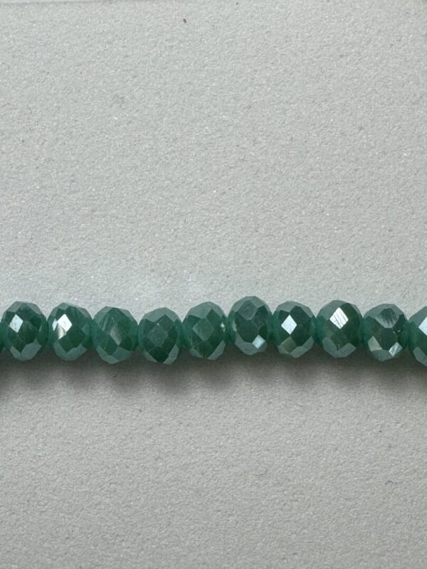 Row of green faceted glass beads.