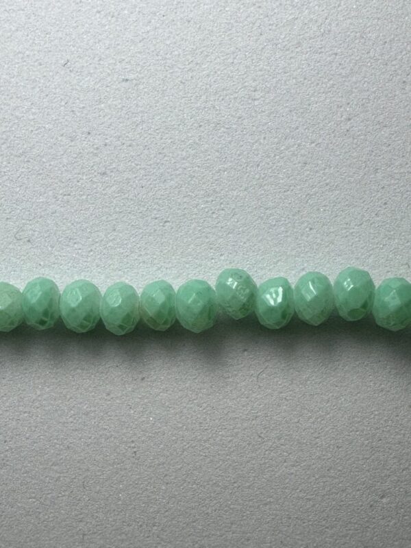 Row of light green faceted beads.