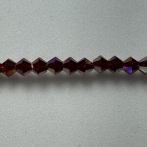Row of dark purple faceted beads.