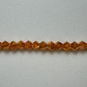 Amber glass beads on gray background.