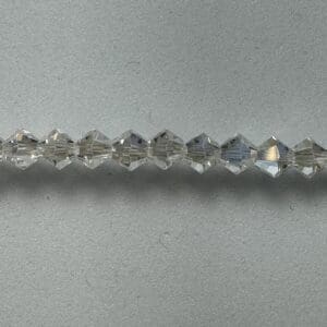 Row of clear faceted glass beads.
