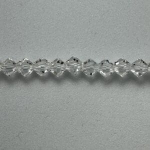Clear crystal beads on grey background.