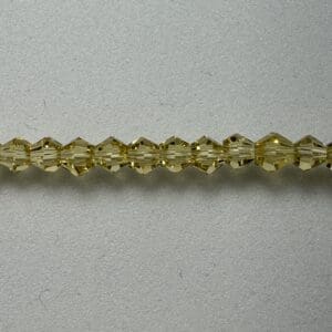 Amber glass beads on grey background.