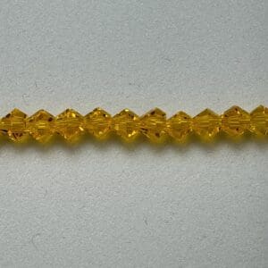 Amber glass beads on gray background.