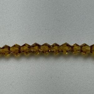 Amber glass beads on white background.