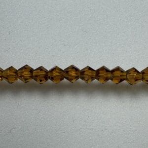 Amber glass beads on gray background.