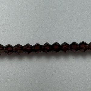 Row of dark brown faceted beads.