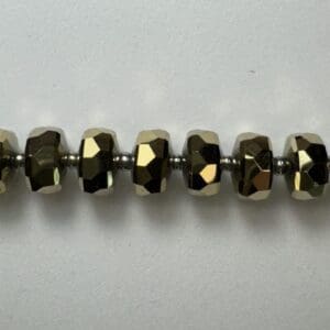 Gold faceted beads on wire.