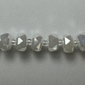 White faceted glass beads strand.