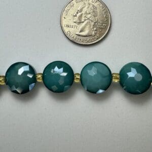Green faceted beads with gold spacers.