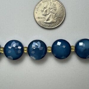 Dark blue faceted beads with gold spacers.