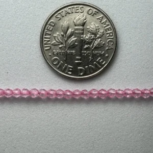 Pink beads with dime for scale.