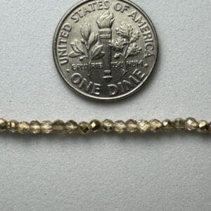 Gold beads with dime for scale.