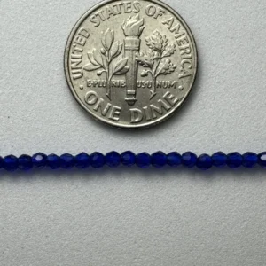 US dime and blue glass beads.