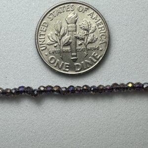 Dark purple beads with dime for scale.
