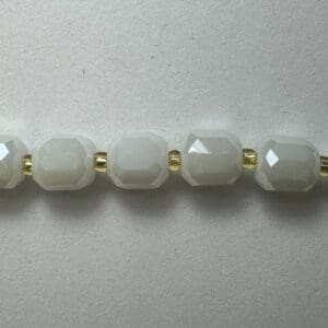 White faceted beads gold necklace.