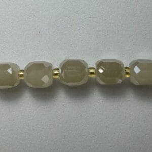 Grey gemstone necklace detail.