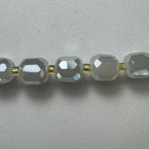 Gray faceted beads gold spacers necklace.