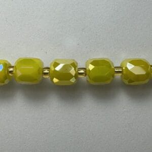 Green glass beads with gold spacers.