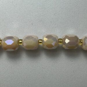 Beige glass beads with gold spacers.