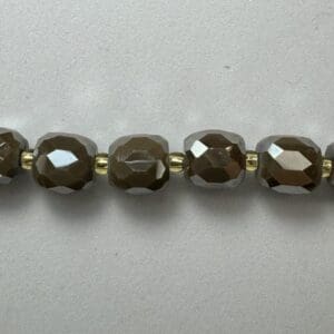Brown faceted beads gold spacers necklace.