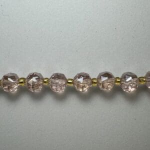 Pink glass bead necklace detail.