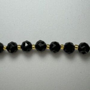 Black crystal beads gold spacers necklace.