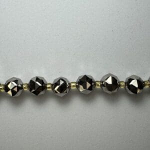 Black faceted beads and gold spacers.
